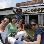 students in a boat outside a restaurant in Vietnam.