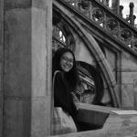 woman with dark hair smiling under an archway