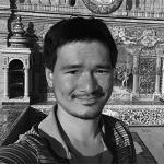 Headshot of a Man in front of a Building