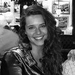 Woman with long dark curly hair. 